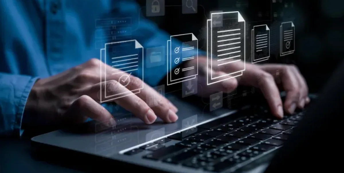 Hands typing on a backlit keyboard with holographic document stacks and cloud data architecture.